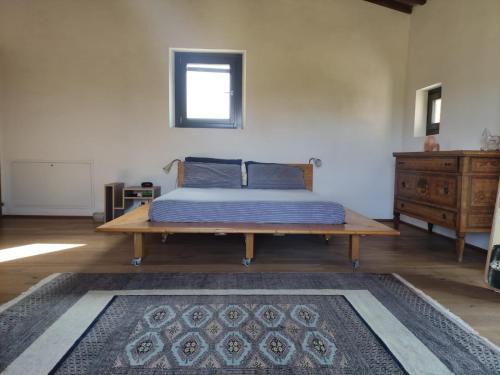 a bedroom with a bed and a wooden table at Casa Matta in Arezzo