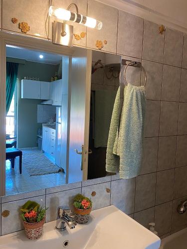 a bathroom with a sink and a mirror at top8 view in Tríkala