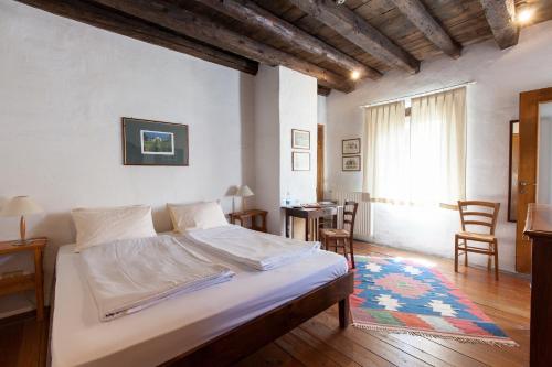 a bedroom with a bed and a table and chairs at Villa Di Tissano in Tissano