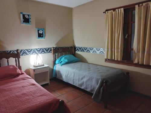 a small bedroom with a bed and a window at Alquiler de casa en Rio Grande Tierra del Fuego in Río Grande