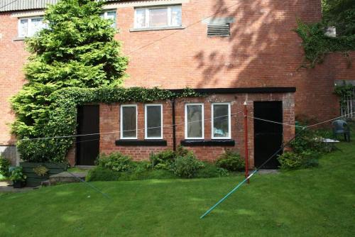 a house with a yard with a kite in the grass at Bellevue Bute, Luxury 2 bedroom sea view flat in Rothesay
