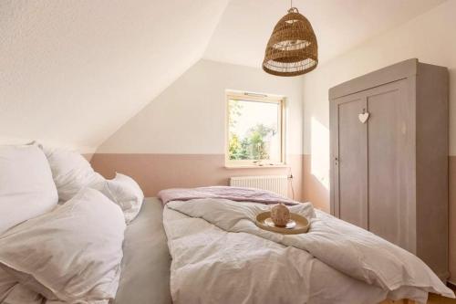 a bedroom with a bed with a tray on it at Leichtes Gepäck in Pellworm