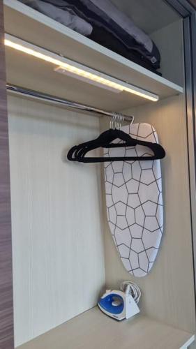 a cupboard with a mirror and a purse at HarbourBay Residence. Batam. Studio. 1min to Ferry in Jodoh