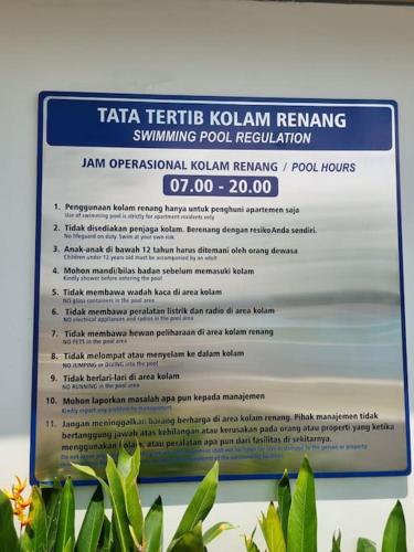 a sign for a kodaete tennis kushimaeng swimming pool revision at HarbourBay Residence. Batam. Studio. 1min to Ferry in Jodoh
