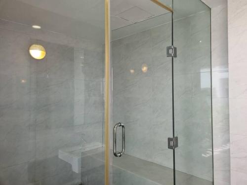 a shower with a glass door in a bathroom at HarbourBay Residence. Batam. Studio. 1min to Ferry in Jodoh