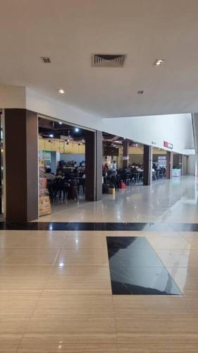 an empty lobby with a dining area in a building at HarbourBay Residence. Batam. Studio. 1min to Ferry in Jodoh