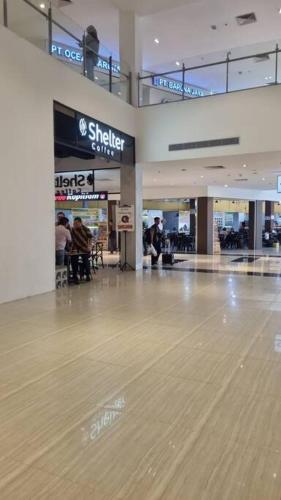 an empty mall with a wooden floor in a shopping mall at HarbourBay Residence. Batam. Studio. 1min to Ferry in Jodoh