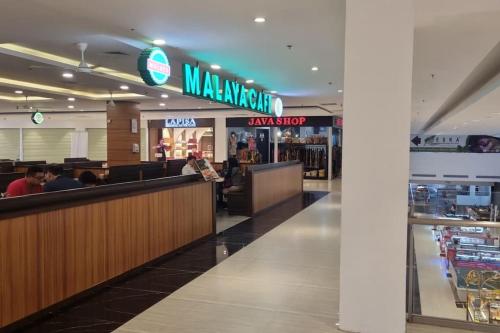 a mcdonalds restaurant with people sitting at the counter at HarbourBay Residence. Batam. Studio. 1min to Ferry in Jodoh