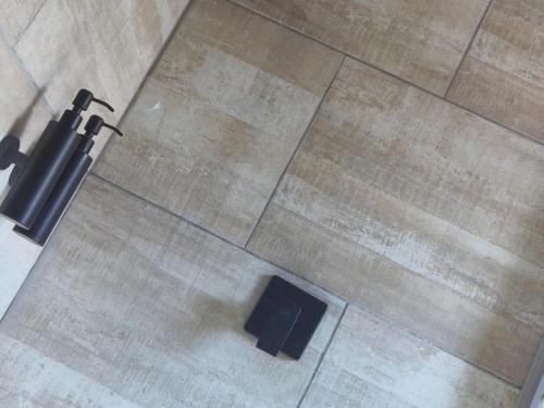 an overhead view of a black object on a floor at Tshepang Apartments Secunda in Secunda