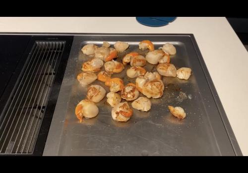 a tray with cauliflower and carrots on a stove at un endroit de rêve in Marseillan