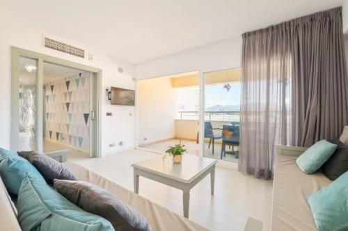 a living room with a couch and a table at Aparthotel Duva & Spa in Port de Pollensa