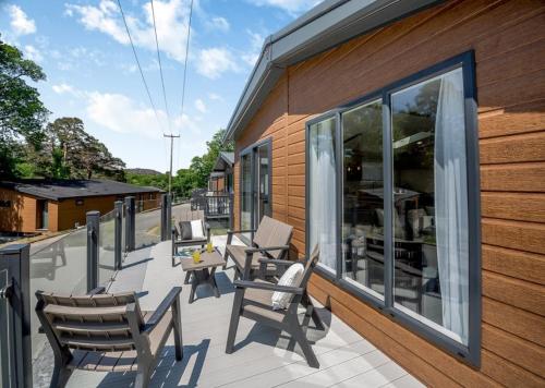 a deck with chairs and tables on a building at C03 - The Faraday in Bangor