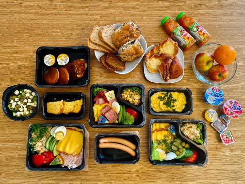 a table with trays of different types of food at Aparthotel Prestige & SPA in Zakopane