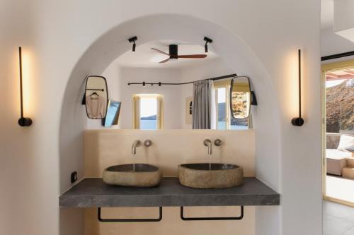 two sinks in a bathroom with a mirror at Anassa Boutique Hotel in Livadi Astypalaias