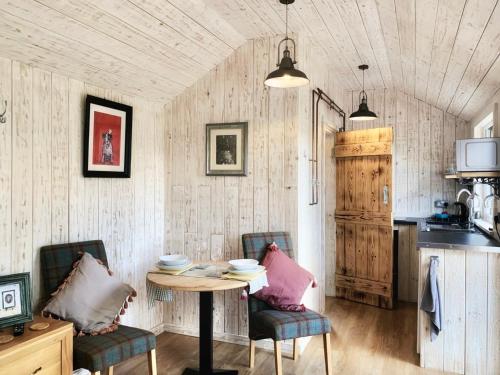 a dining room with a table and chairs and a kitchen at Holiday Lodges with hot tub & Cosy Cabins - Greenway Farm, Drybrook, Forest of Dean in Drybrook