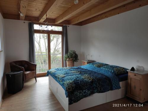 a bedroom with a bed and a large window at Ferienhaus Haslberger in Waging am See