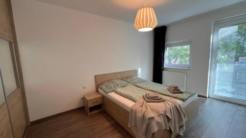 a bedroom with a bed with a blanket on it at 2 room apartment, Old City, new building - Stein in Bratislava