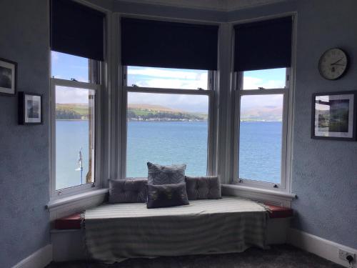 a window seat with a view of the water at Bellevue Bute, Luxury 2 bedroom sea view flat in Rothesay