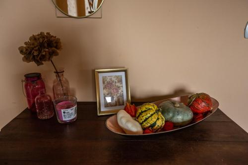 a bowl of vegetables on a table with a picture at #914 Home - Irpinia in Nusco