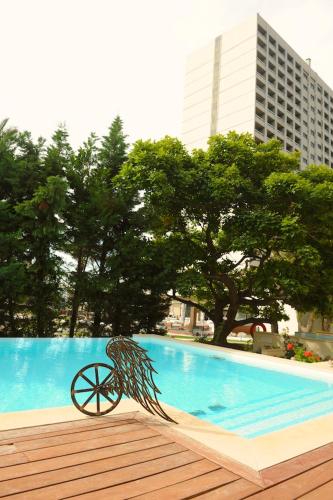 a metal object sitting next to a swimming pool at ABAV2 Suites by Rodos Palace in Ixia