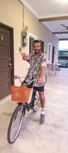 a man is sitting on a bike with his hand at GLG KLIA Transit House in Sepang
