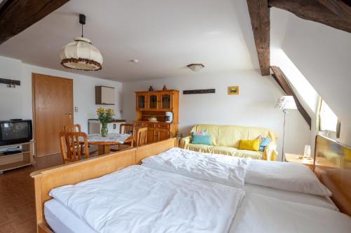 a bedroom with a bed and a living room at Ferienhaus Helga in Absberg