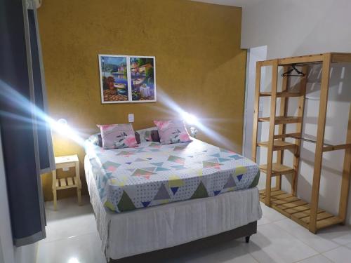 a small bedroom with a bed and a ladder at Studio Mar & Sol in Armacao dos Buzios
