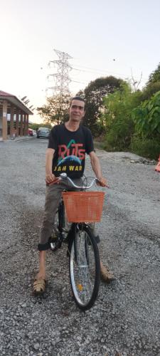 a man sitting on a bike with a basket at GLG KLIA Transit House in Sepang