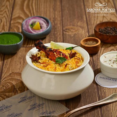 a white bowl of food on a table at The Ashtan Sarovar Portico in New Delhi