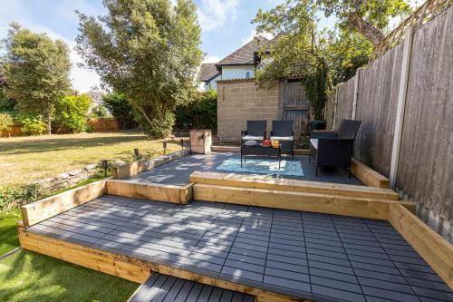 a backyard with a deck and a fence at Queens Park Views by Grandeur Property in Bournemouth