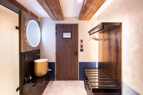 a bathroom with a sink and a wooden door at Mister Highland Hotel in Amsterdam