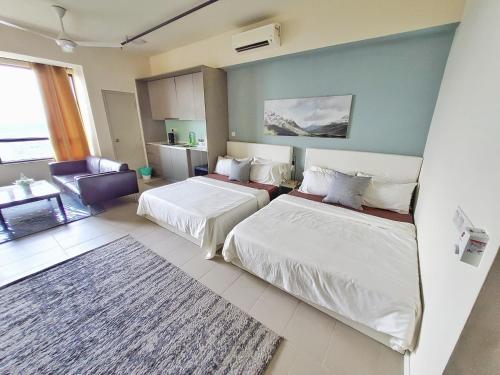 a bedroom with two beds and a living room at Tamarind Suites or D'Pulze Residence or Domain NeoCyber, click Room selection for location and pics in Cyberjaya