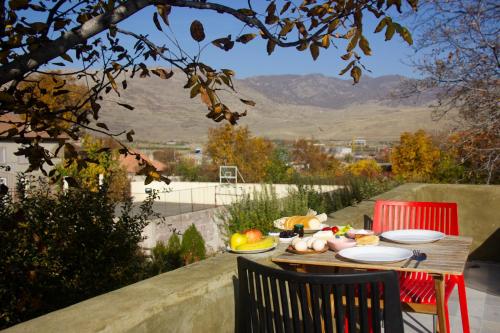 uma mesa de madeira com pratos de comida em Zove Rural Cottage with garden views em Kʼarashamb