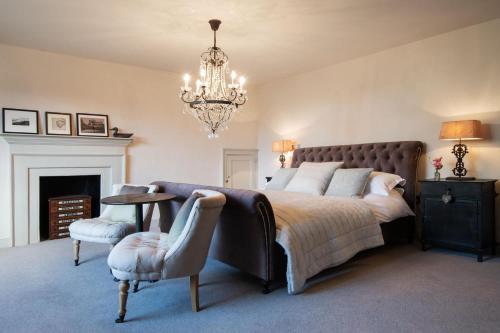 a bedroom with a large bed and a chandelier at Mole House in South Pool