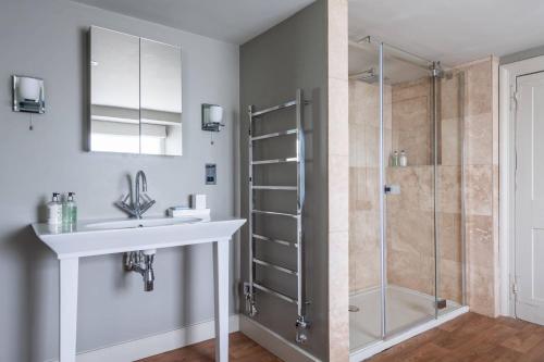 a bathroom with a sink and a shower at Mole House in South Pool