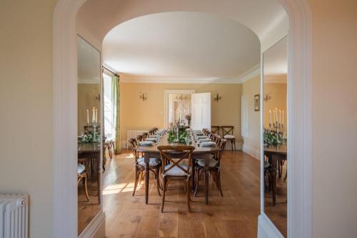 uma sala de jantar com mesa e cadeiras em Mulberry House em Holbeton