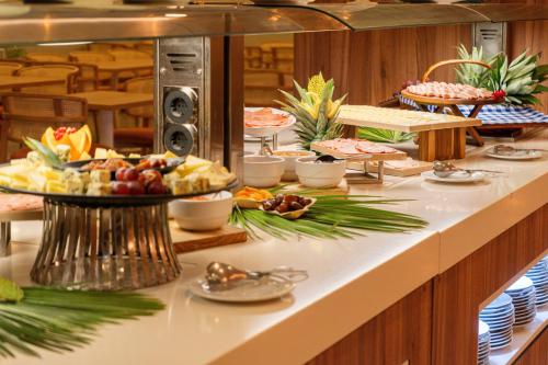 a buffet line with various food items on it at Aqualuz Troia Mar by The Editory in Troia