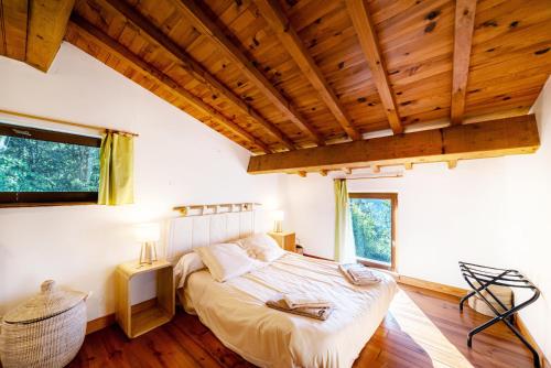a bedroom with a bed and a wooden ceiling at Villa la Finca in Montferrer