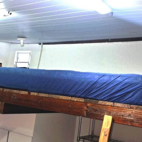 a bunk bed in a room with a blue sheet at Tiny House da Tata in Florianópolis