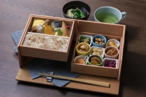 a wooden box filled with different types of food at Candeo Hotels Kyoto Karasuma Rokkaku in Kyoto