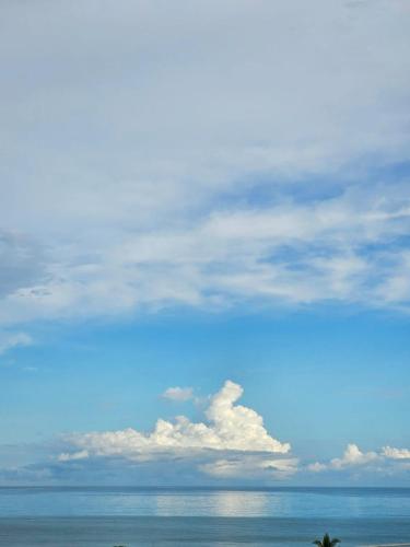 a view of the ocean with a blue sky and clouds at Casa Norte North Beach in Los Órganos