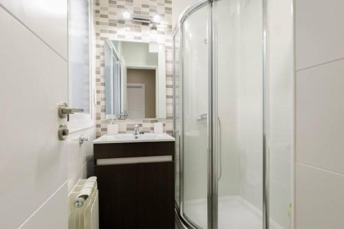 a bathroom with a glass shower and a sink at Sara Love Downtown in Granada