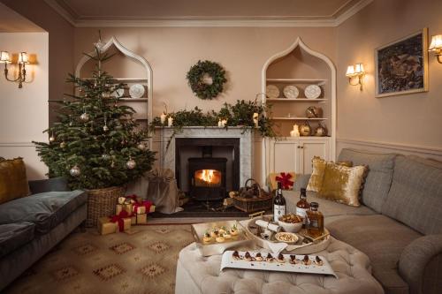a living room with a christmas tree and a fireplace at Tacket Wood House in Kingsbridge
