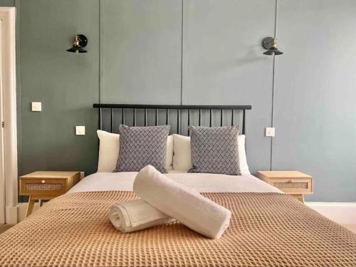 a bedroom with a large bed with a pillow on it at Spacious 3 Bedroom Home In Glasgow - Free Parking in Glasgow