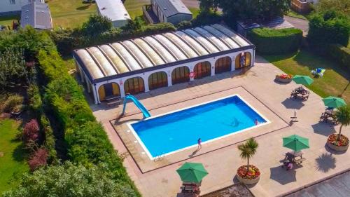 an overhead view of a swimming pool in front of a building at White Rose Cottages, Near Thirsk in Thirsk