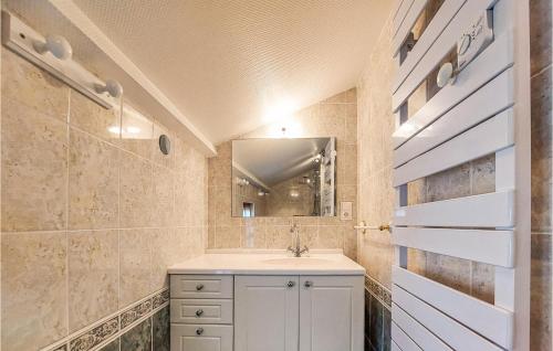 a bathroom with a sink and a mirror at Gite Rural Le Couvent in Riom-ès-Montagnes