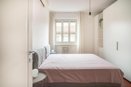 a bedroom with a bed and a window at Isola Milano apartment in Milan