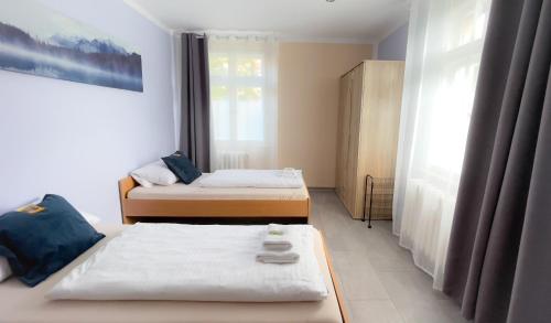 a bedroom with two beds and a window at MOTEL DARIA Hennigsdorf Berlin in Hennigsdorf