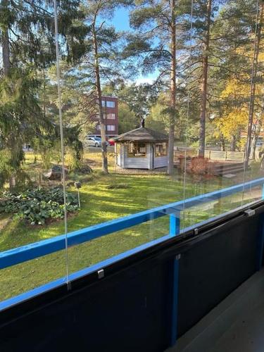 a window view of a yard with a gazebo at Welcomly apartment MILA in Kotka
