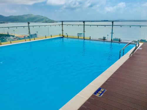 a large swimming pool on a pier with the water at Rustic Hotel Quy Nhon Powered by ASTON in Quy Nhon